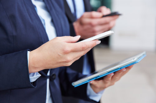 Businesswoman using mobile devices